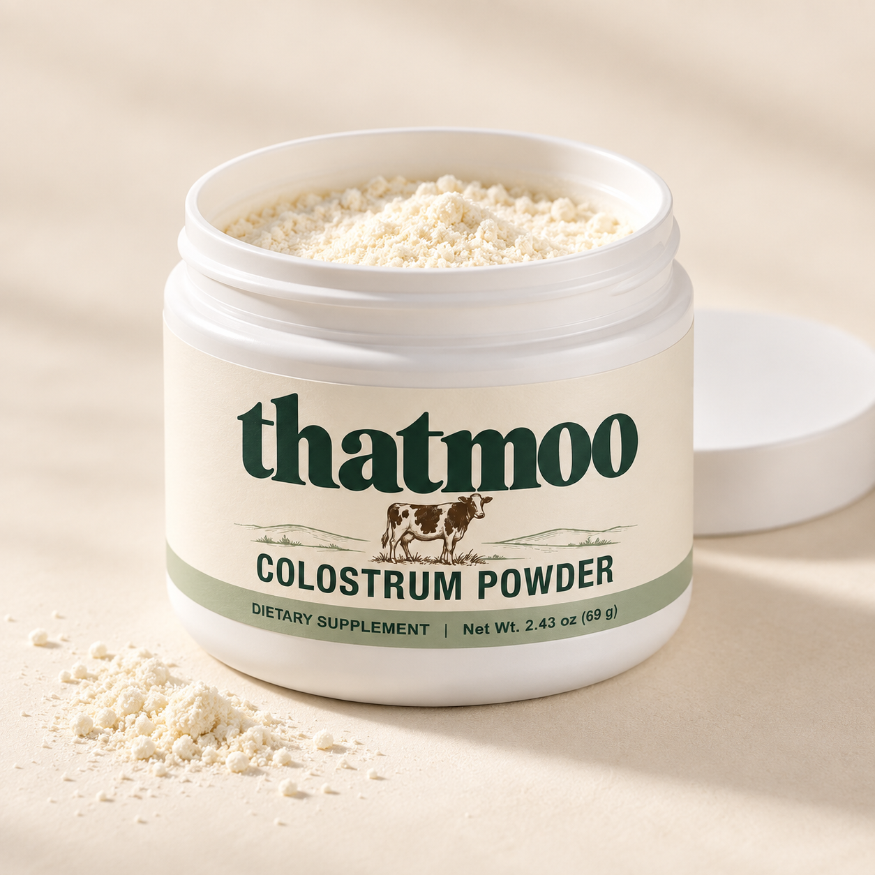 Open ThatMoo jar showing colostrum powder with its lid beside it; illustrative texture and fill level